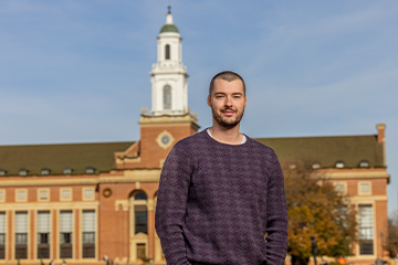 Bennett Upton stands with OSU's Edmon Low Library in the background.