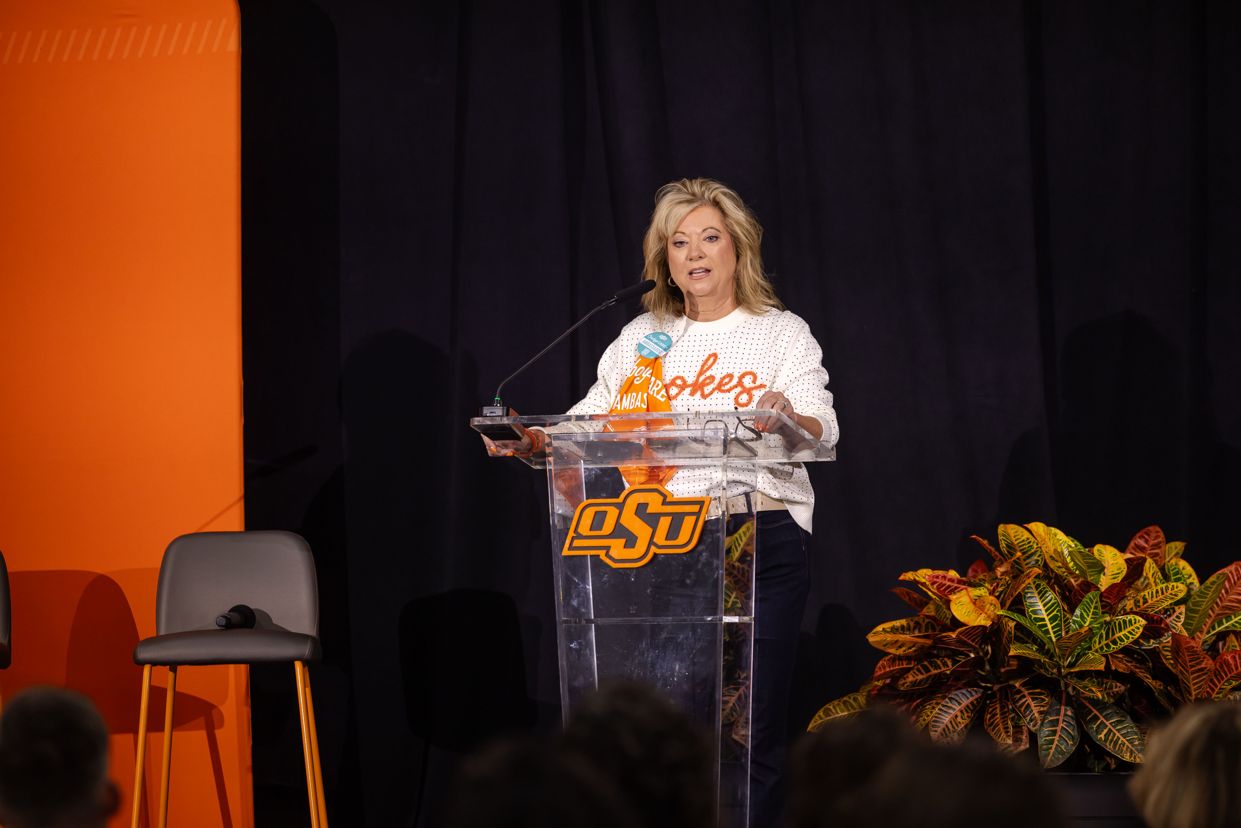 Angela Hess speaks from a podium