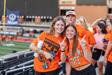 Two female students give a 