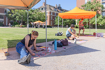 Students participate in a campus chalk-art event that highlights and celebrates Oklahoma State University research, using creative sidewalk illustrations to share scientific ideas and discoveries with the broader campus community.