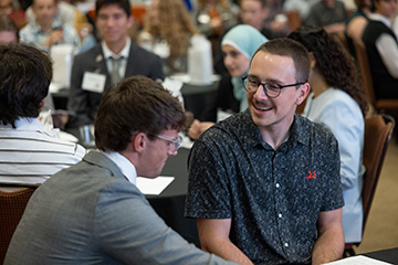 Two Niblack Research Scholars talk during the annual OSU research symposium, where undergraduate students presented research projects completed through hands-on laboratory experience and faculty mentorship.