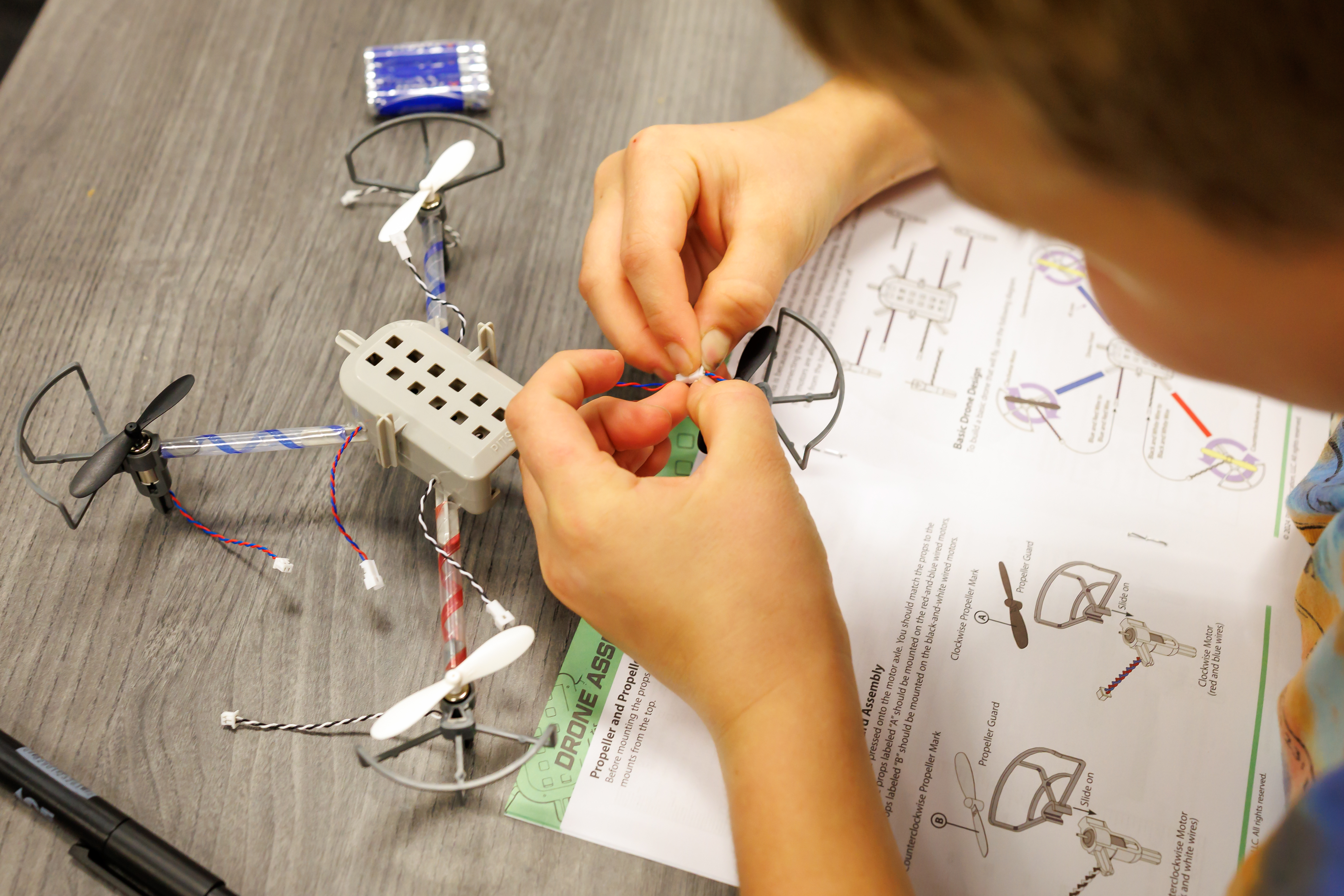 A student builds a drone with step by step instructions.