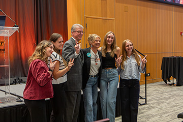 A group poses together during the fifth Cowboys Care graduation ceremony at Oklahoma State University, where 276 new ambassadors joined the campus mental health initiative.