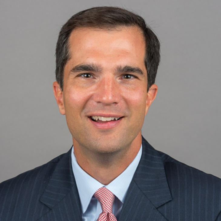 Professional headshot of Jeff Starling, who has been named executive director of Oklahoma State University’s Hamm Institute for American Energy, wearing a dark suit, light blue shirt and patterned tie against a gray background.