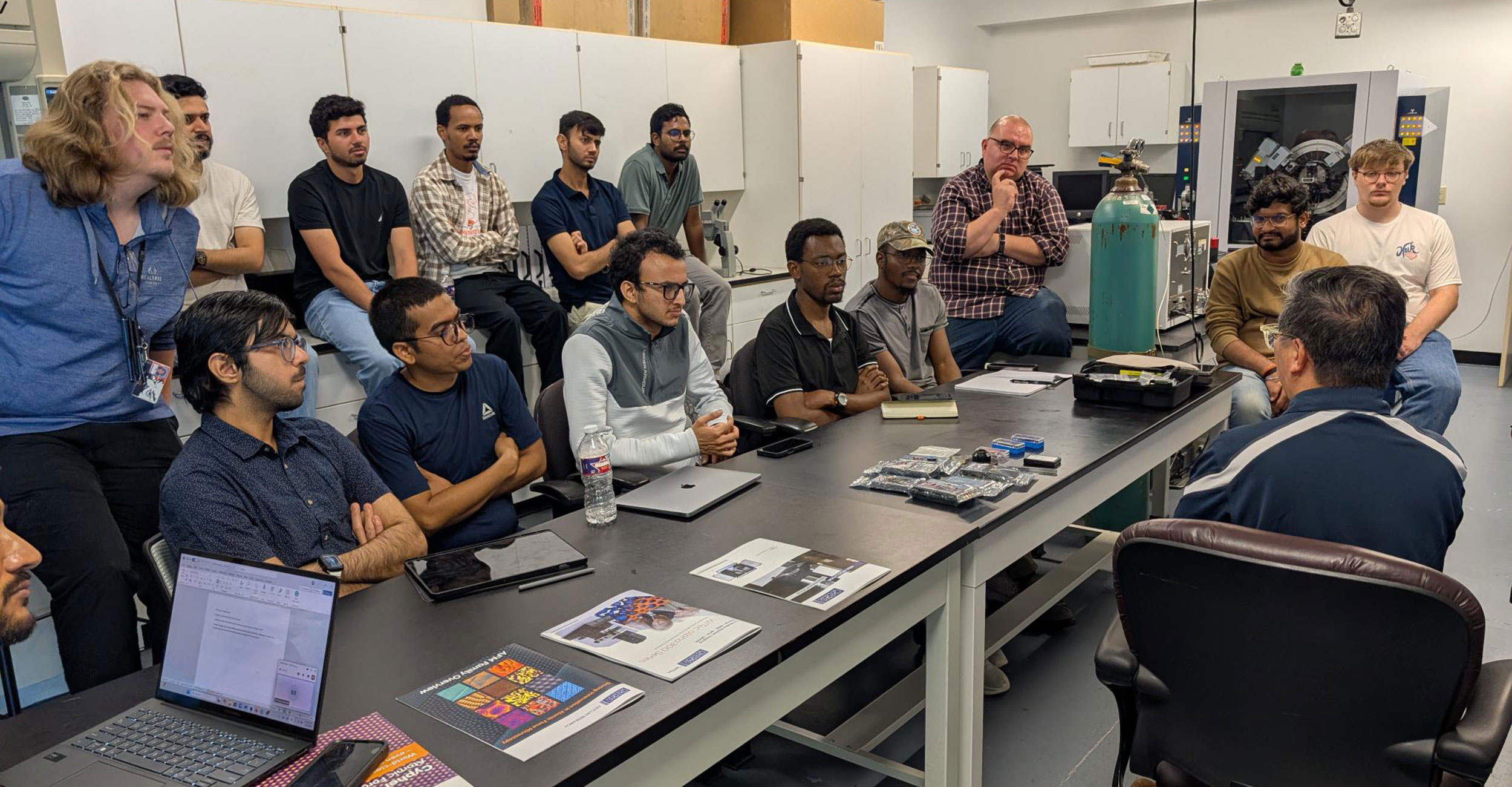 a group of scientists sit at a table