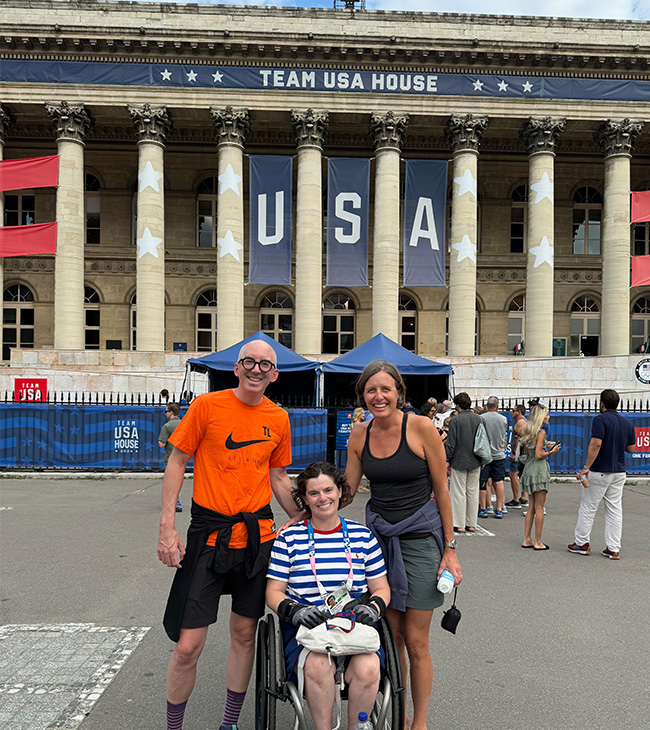 Cassie Mitchell and her freidns in front of the Team USA ho