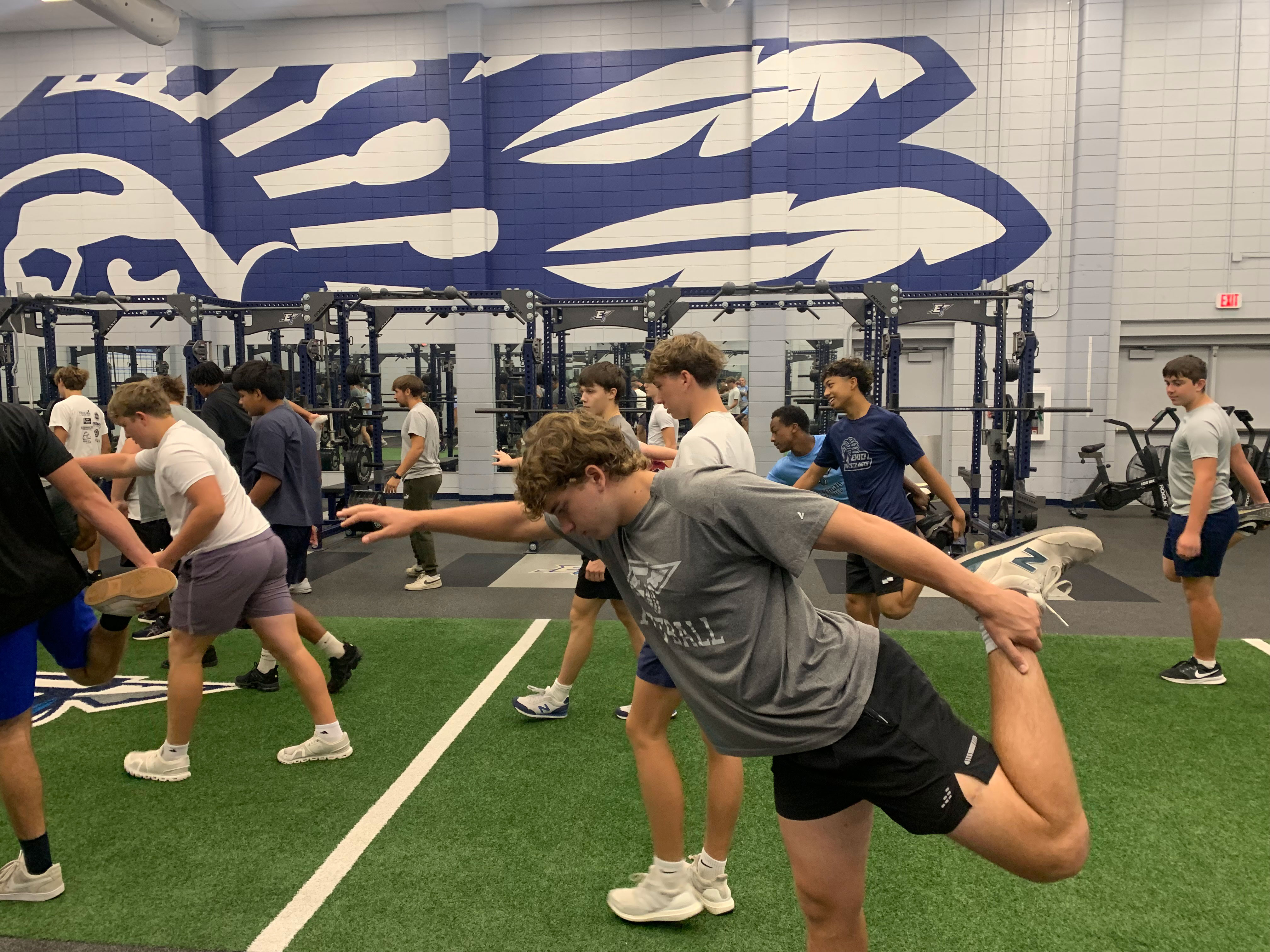 high school athletes warm-up in a gym