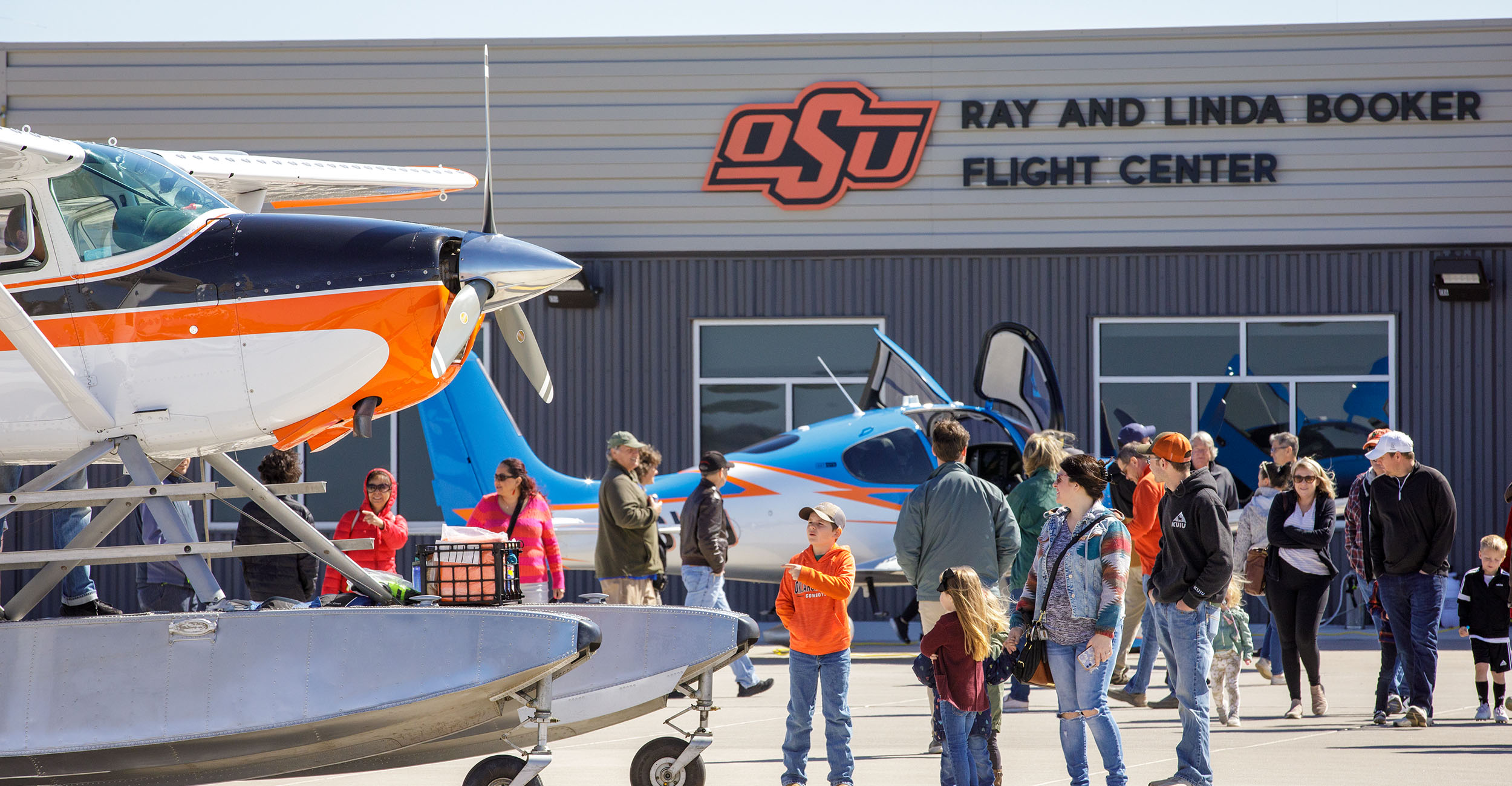 A military aircraft flies into the OSU Ray and Linda Booker Flight Center at Stillwater Regional Airport