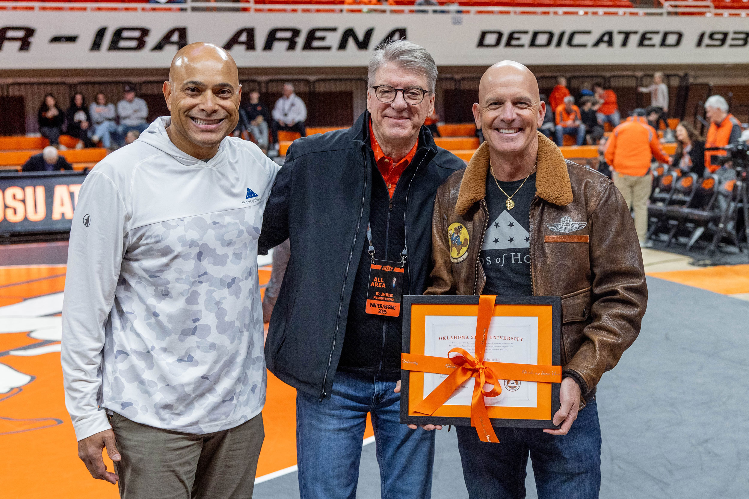 Luke Sherman of Folds of Honor, OSU President Jim Hess, and Lt. Col. Dan Rooney of Folds of Honor stand for a photo holding a certificate to signify their new partnership.