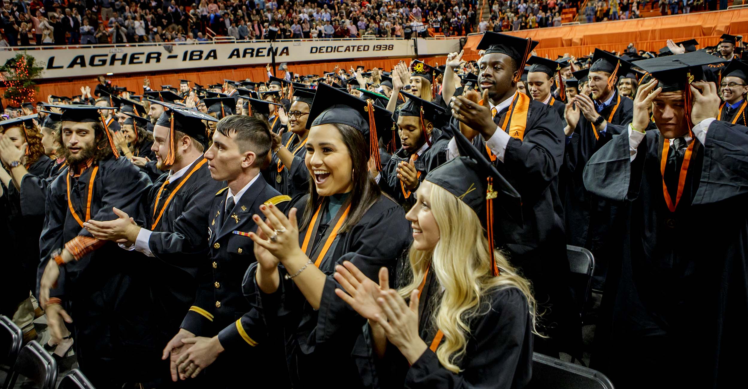 Graduates celebrate inside Gallagher-Iba Arena in 2019.