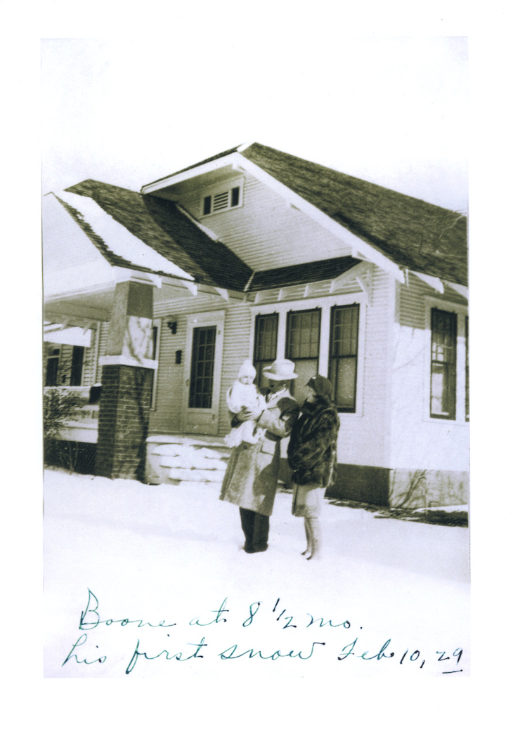 An infant Boone Pickens takes in his first snow with his parents outside of his childhood home in Holdenville, Oklahoma. The photo was taken on Feb. 10, 1929 when Pickens was nearly nine months old.