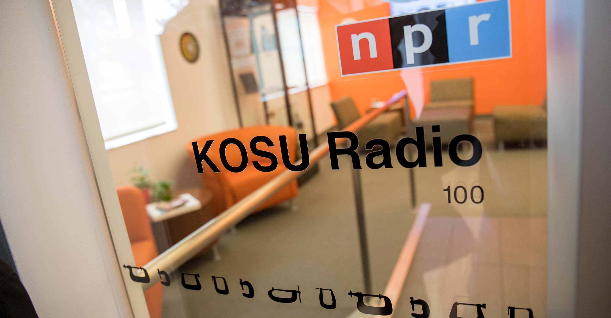 A door to the KOSU studio in the School of Media and Strategic Communications.