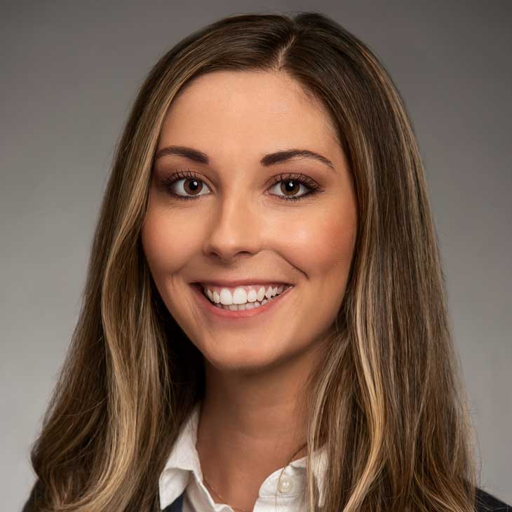 a headshot of a caucasian female wearing a suit