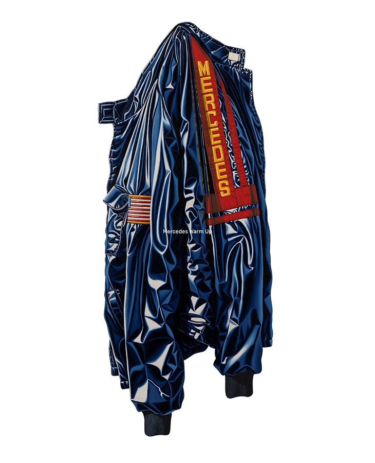 Framed artwork depicting a shiny blue racing jacket with red trim and the word “MERCEDES” displayed vertically on one side against a plain background.