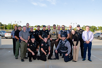 Members of the Oklahoma State University Police Department and local law enforcement partners who participate in Project Safe Stop pose for a group photo.