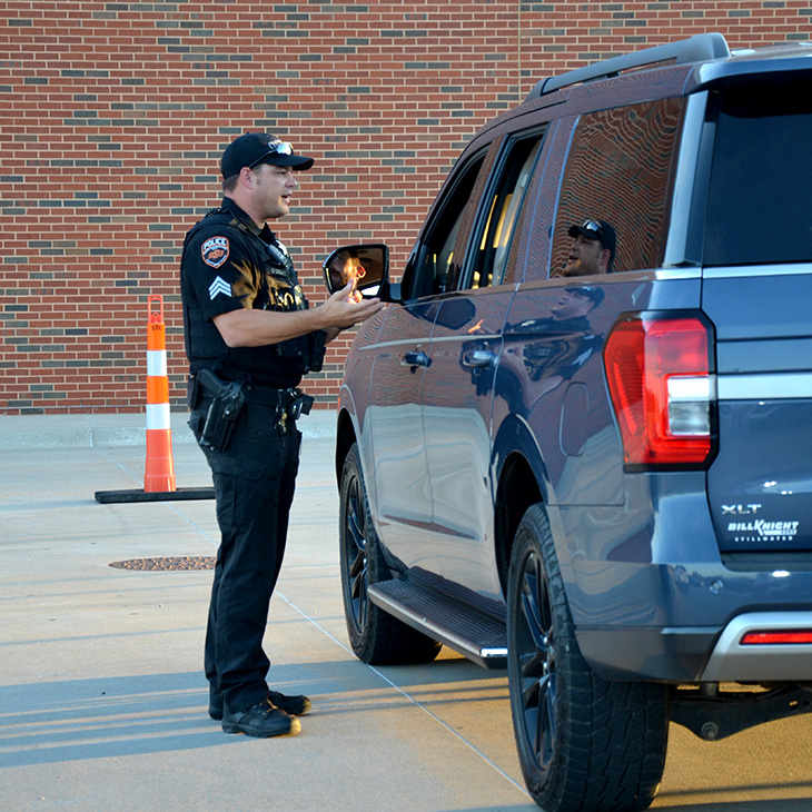 An OSU Police officer participates in a Project Safe Stop training scenario, demonstrating communication techniques designed to help law enforcement officers interact more effectively and safely with drivers who may have disabilities or communication differences.