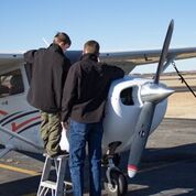 Aviation student working with a boy scout