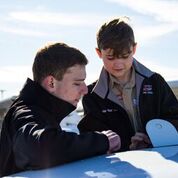 Aviation student working with a boy scout