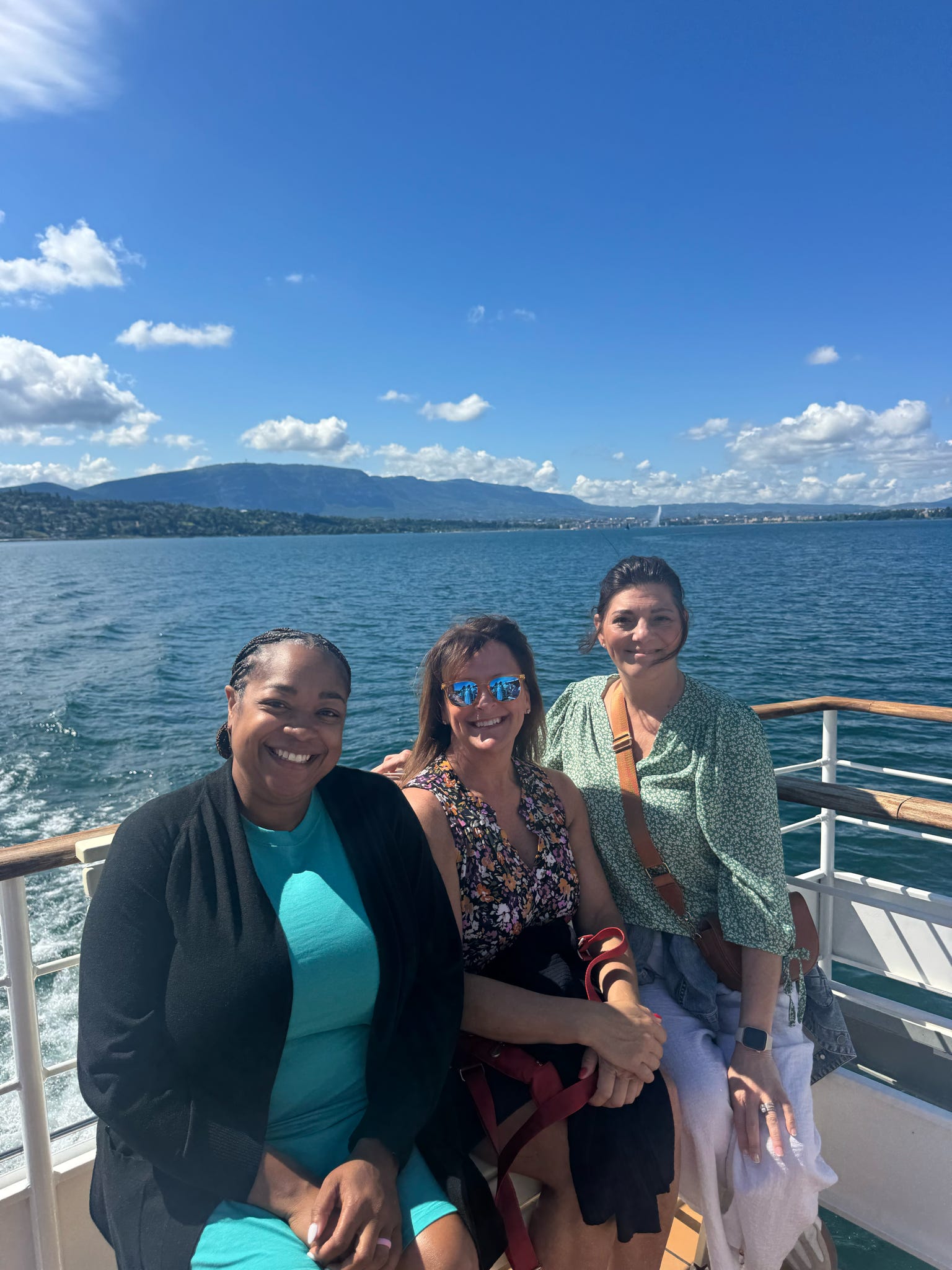 Faculty pose for photo on boat