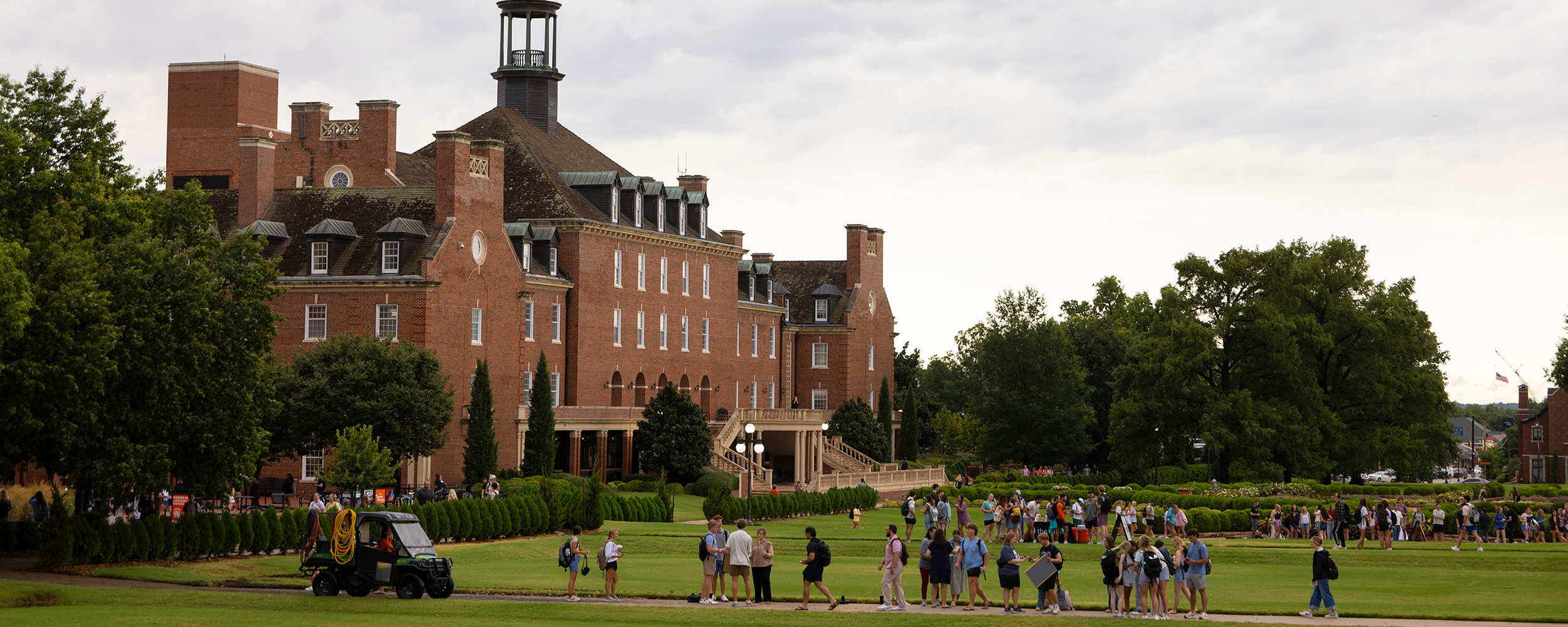view of the OSU Student Union from library lawn as students make their way to class