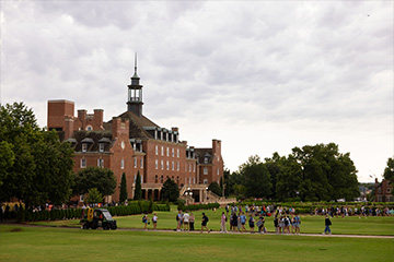 view of the OSU Student Union from library lawn as students make their way to class