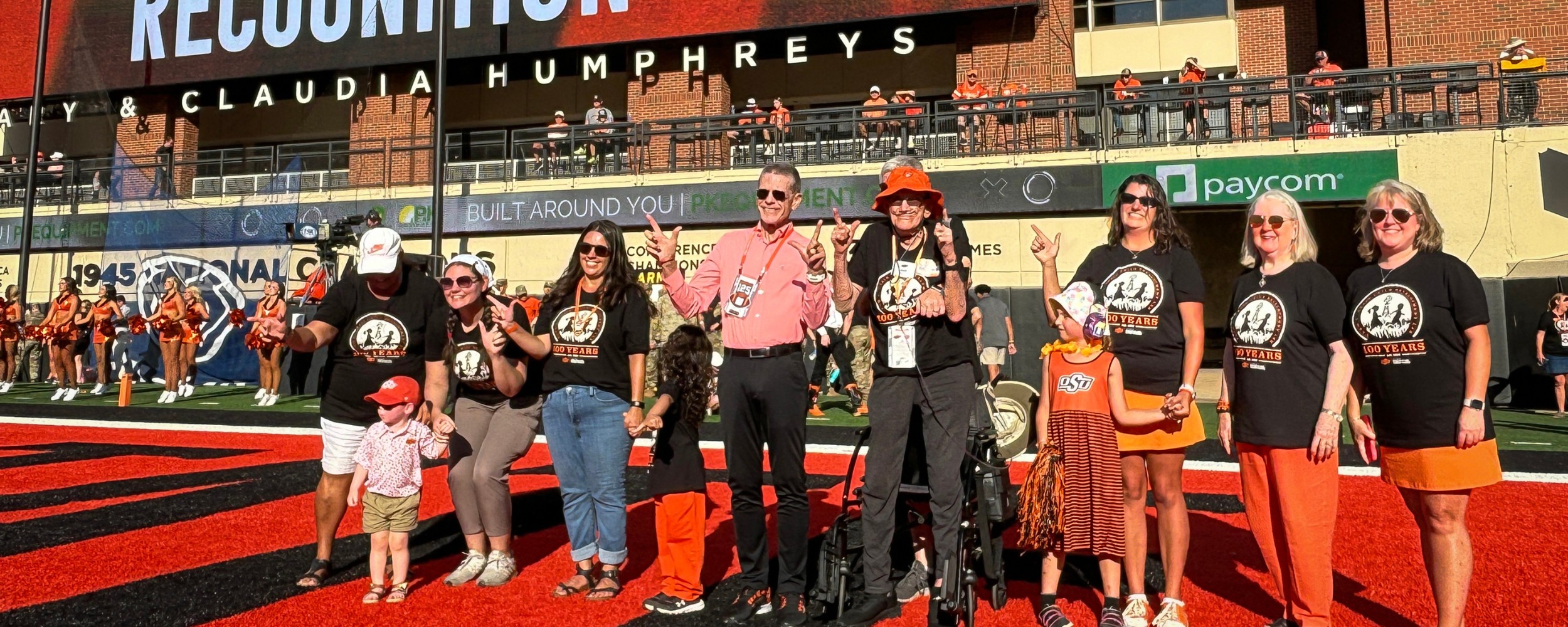 CDL representatives stand on OSU football field for centennial recognition.