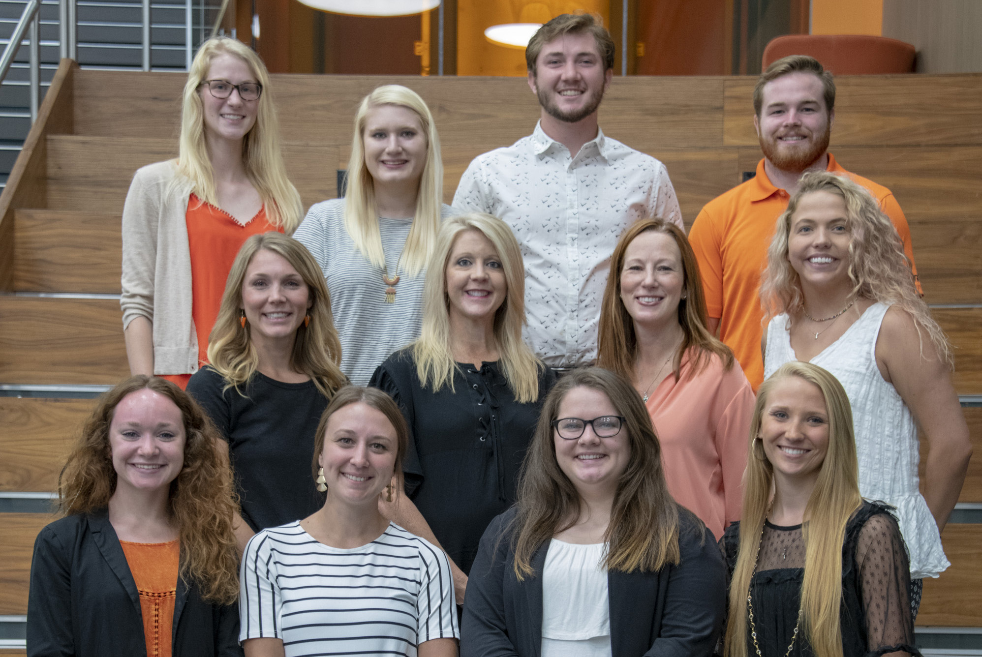 group of students and faculty gather on the stairs for a picture