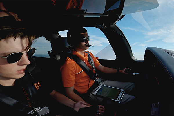 Pilot Branden Adams and co-pilot Dash Ahlstrom in a test flight ahead of Saturday's fly over event.