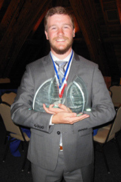 Flying Aggie holding championship trophies