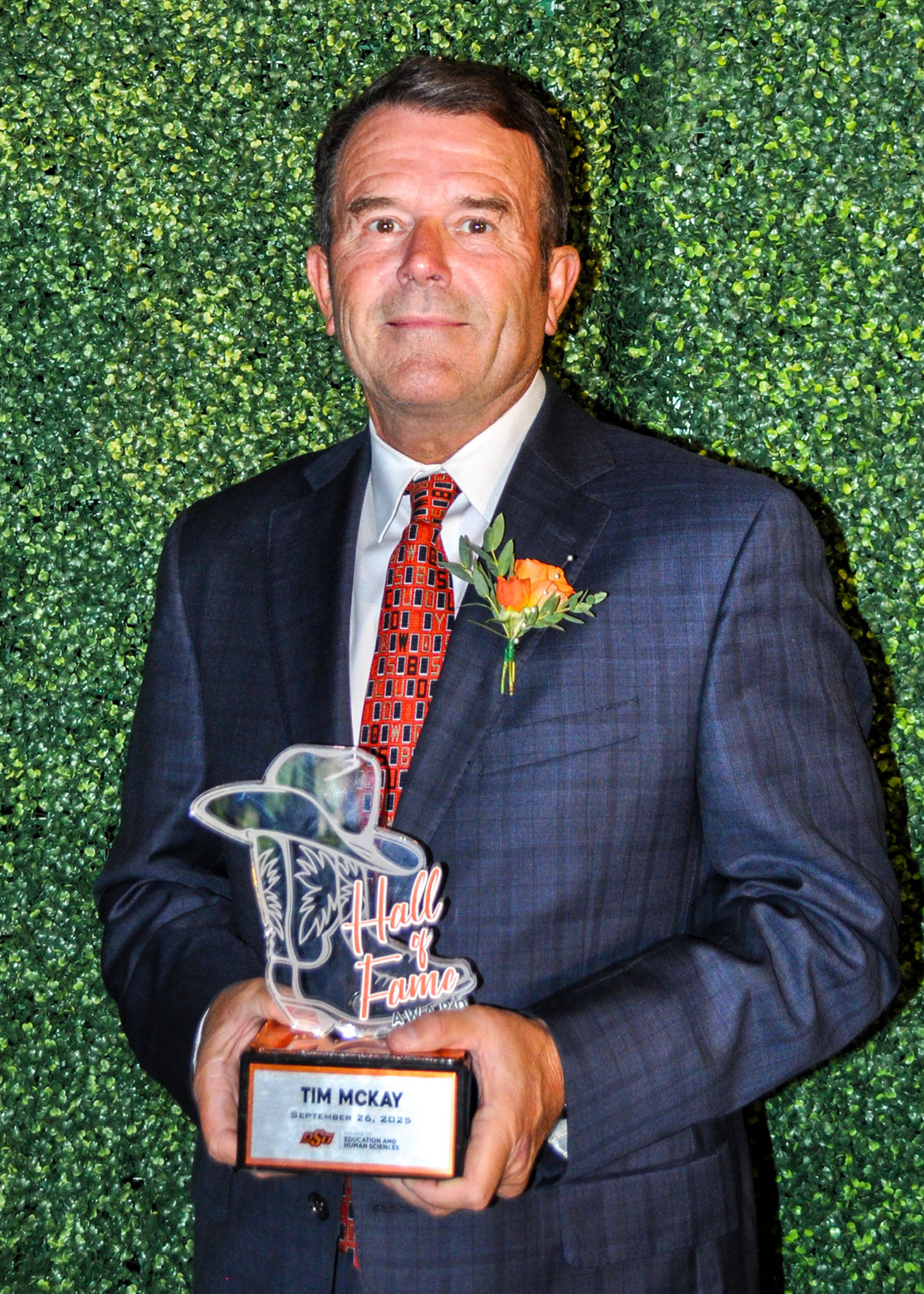 Tim McKay holding Hall of Fame award