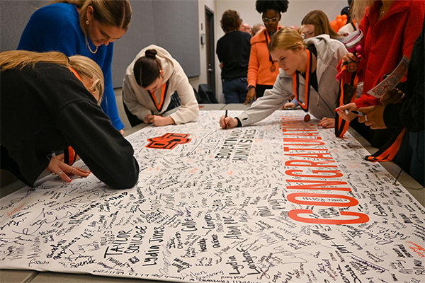 Students sign My First Traditions banner