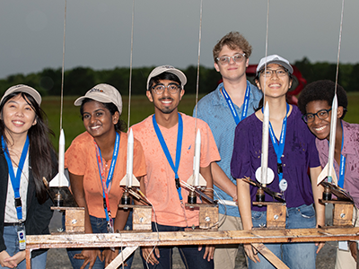 student with model rockets