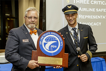 Jon Loffi accepts award