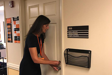An image of Sarah Donovan opening the door to her office