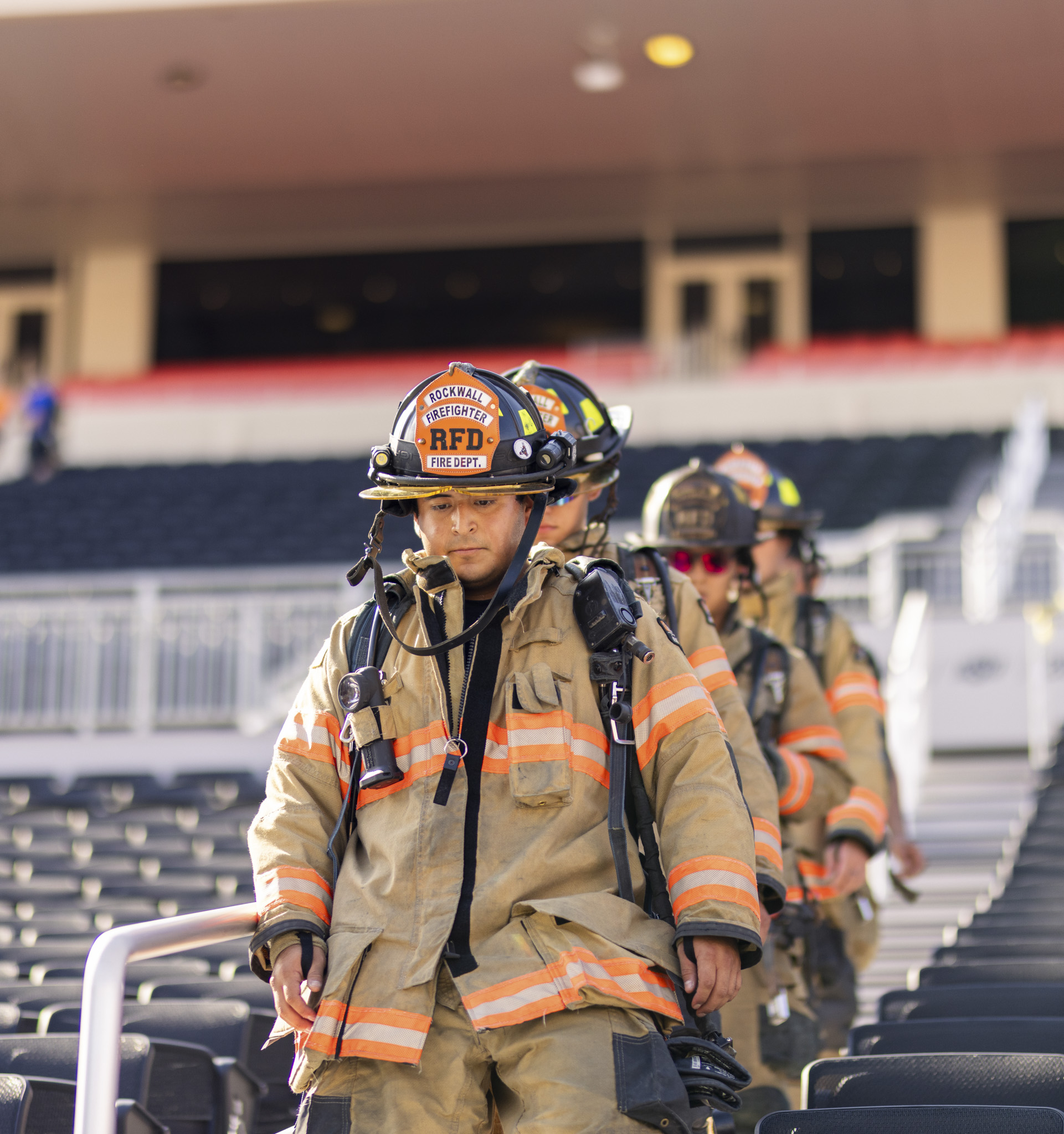 firefighters from Rockwall Texas climbing stairs
