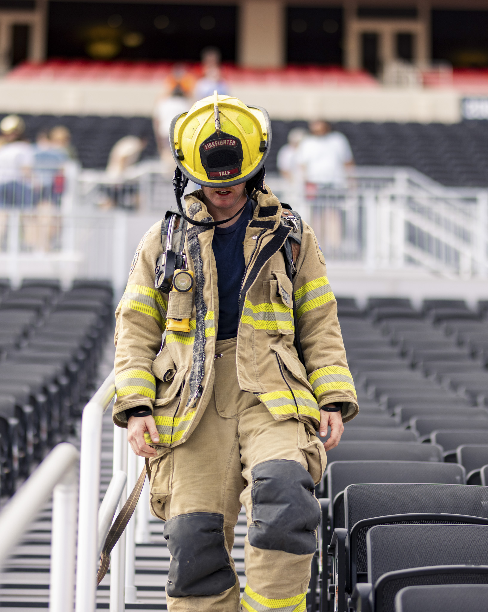 Baylor Cobb climbing stairs in full bunker gear