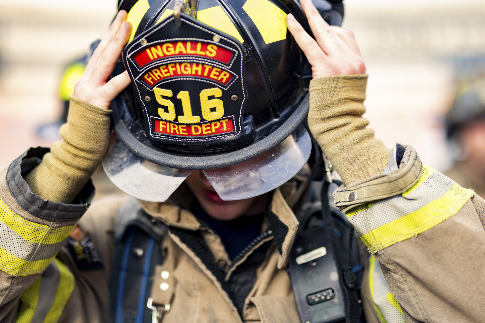 Ingalls firefighter taking of his helmet
