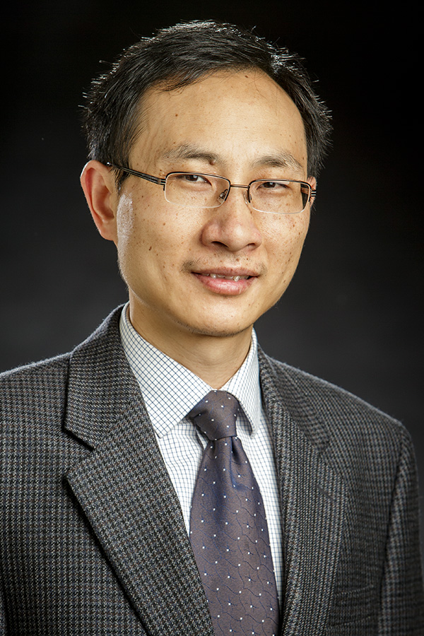 Dr. Joshua Li is shown in a portrai smiling while wearing a suit.