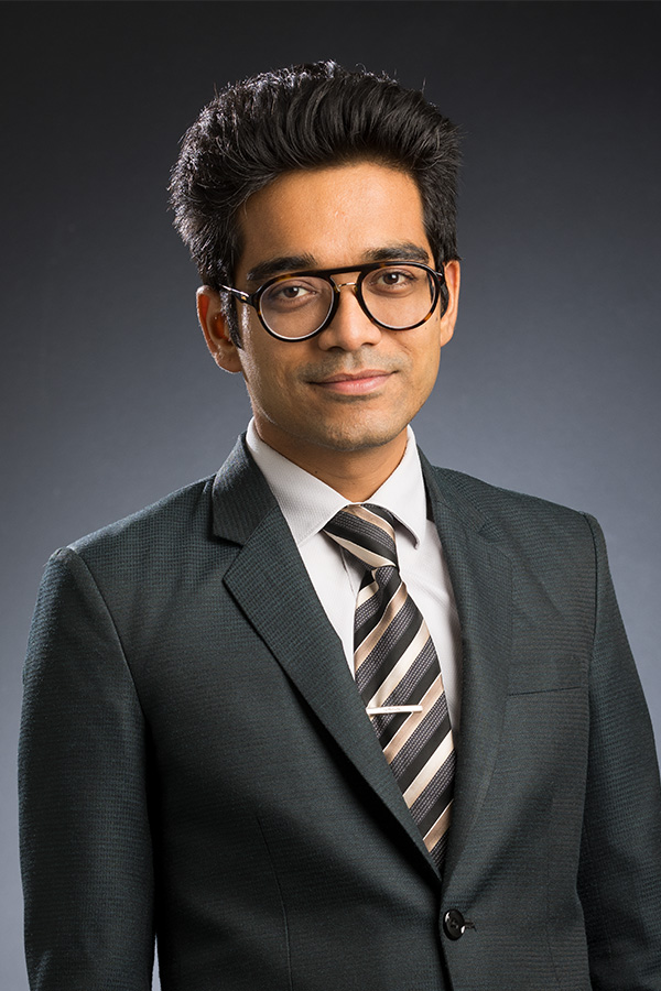 Dr. Pranjal Nautiyal is shown wearing a nice suit in a portrait.