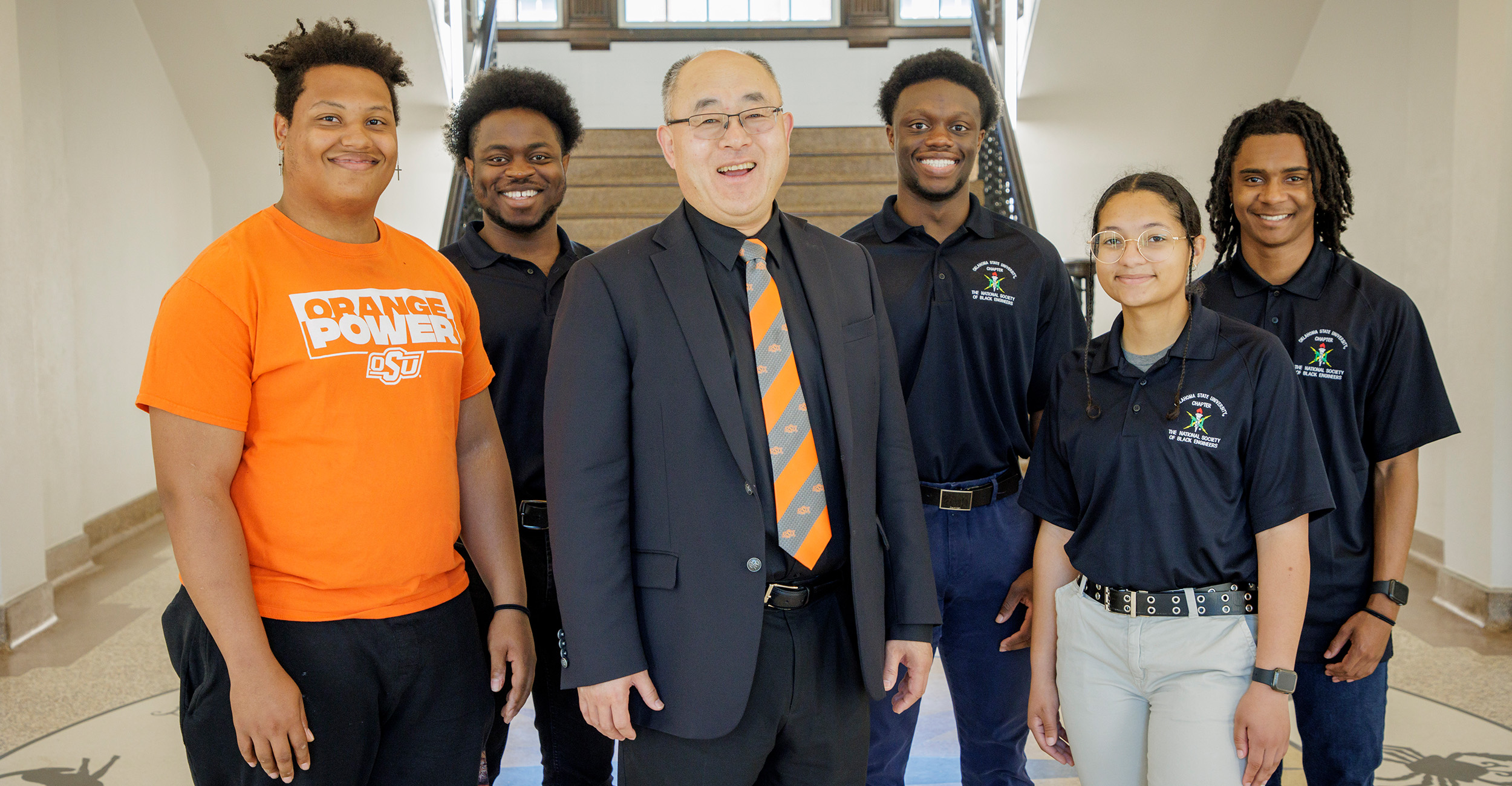 Dean Hanchen Huang of the College of Engineering, Architecture and Technology poses for a photograph with students in the OSU chapter of the National Society of Black Engineers