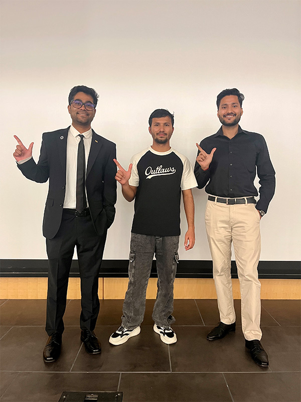 Three men, Vishesh Bhadariya, Bunty Tomar and Suman Poudel, are photographed together following their individual successes in the OSU Three Minute Thesis Competition.