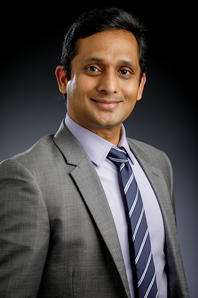 Dr. Prem Bikkina is photographed wearing a suit for a staff portrait.