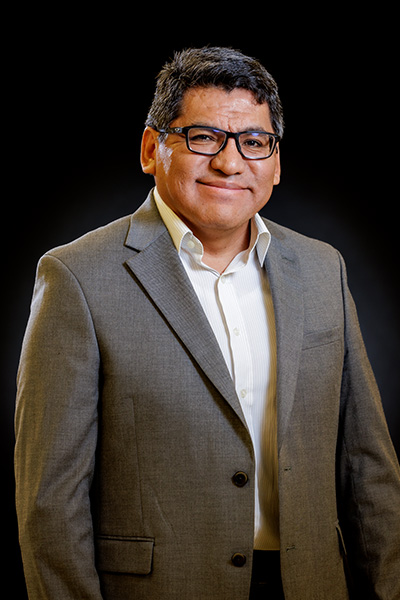 Dr. Javier Vilcaez Perez is shown wearing a suit for a staff portrait.