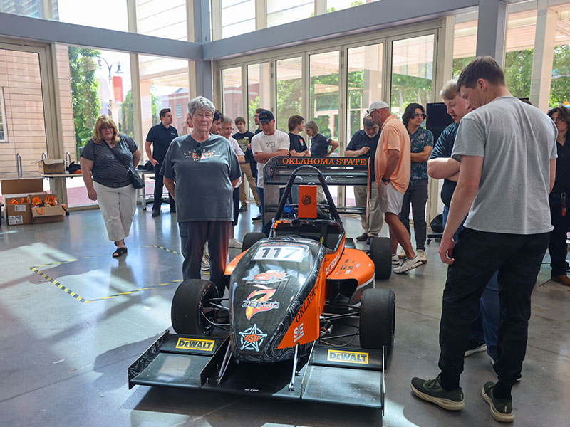 Mary Davey stands beside the Bullet Racing vehicle.