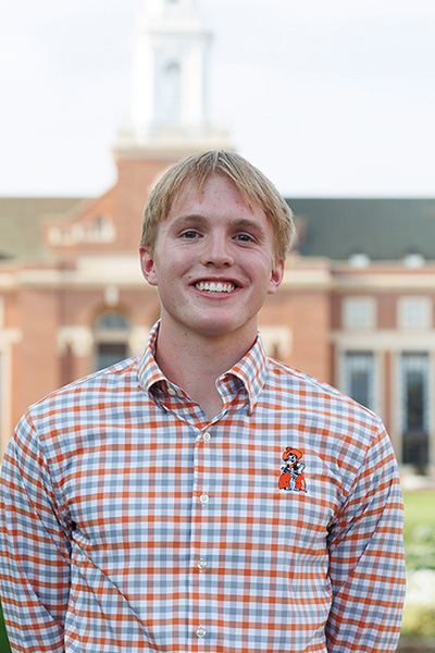 Harrison Oakes, a student in the College of Engineering, Architecture and Technology, was named a Top 20 Freshmen for Oklahoma State University. He is pictured with the OSU library in the background.
