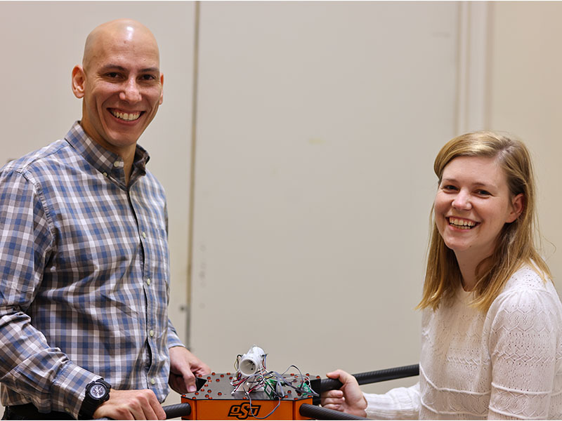 Two researchers holding a UAV.