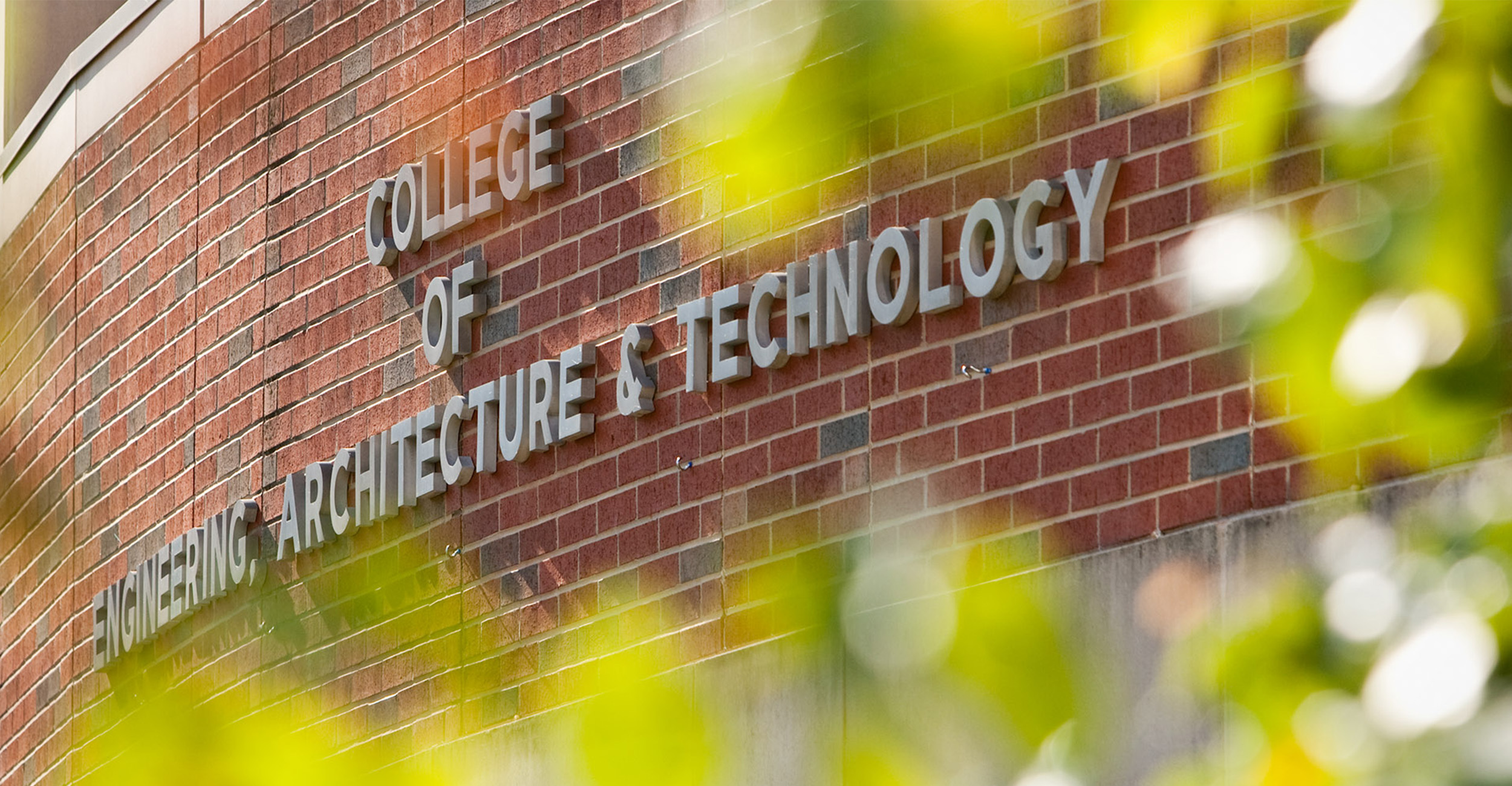 An image of the College of Engineering, Architecture and Technology sign on their north building.