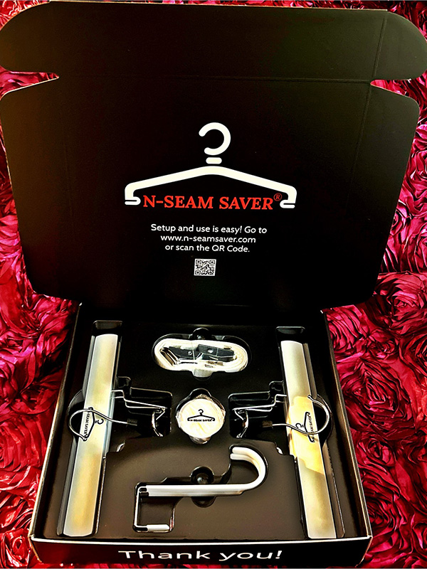 N-Seam Saver invention in black packaging lying on red fabric.