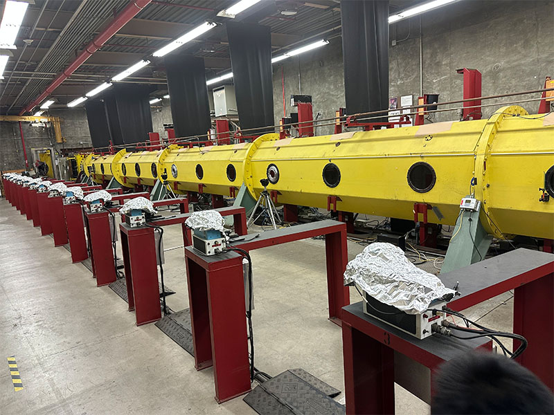 A large yellow,metal tube that is used for testing at NASA.