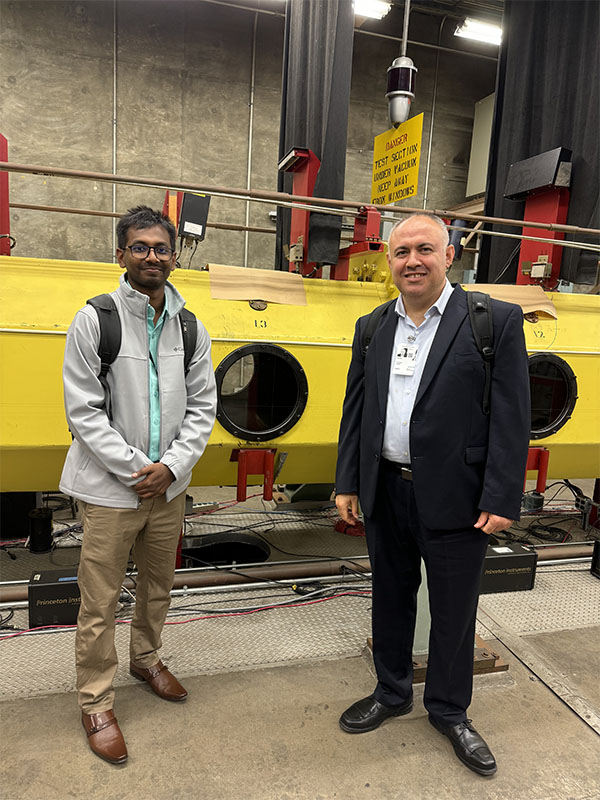 Dr. Kara and a Ph.D. canidate who worked on this research standing inside of a laboratory at NASA facility.